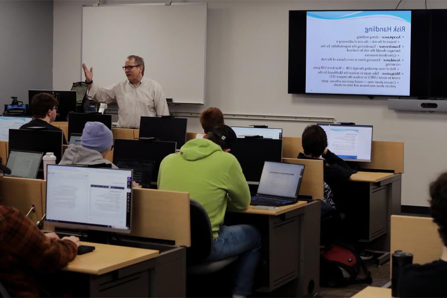 A faculty member speaks to a class.