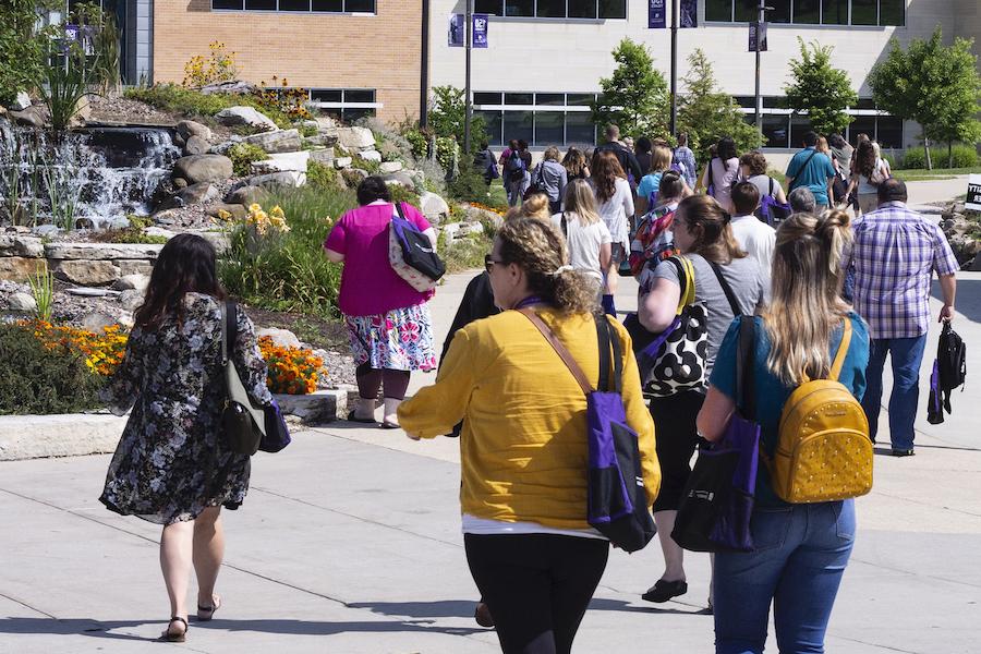 People walking outside on campus during Now is the Time Conference